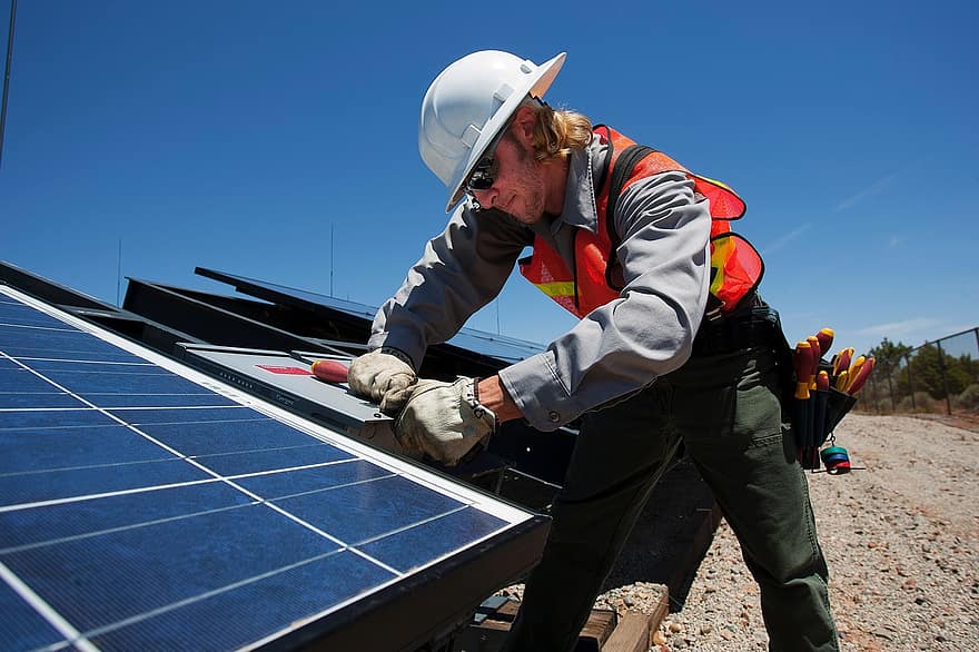 man-working-construction-sawing-wood-building-solar-panel-worker